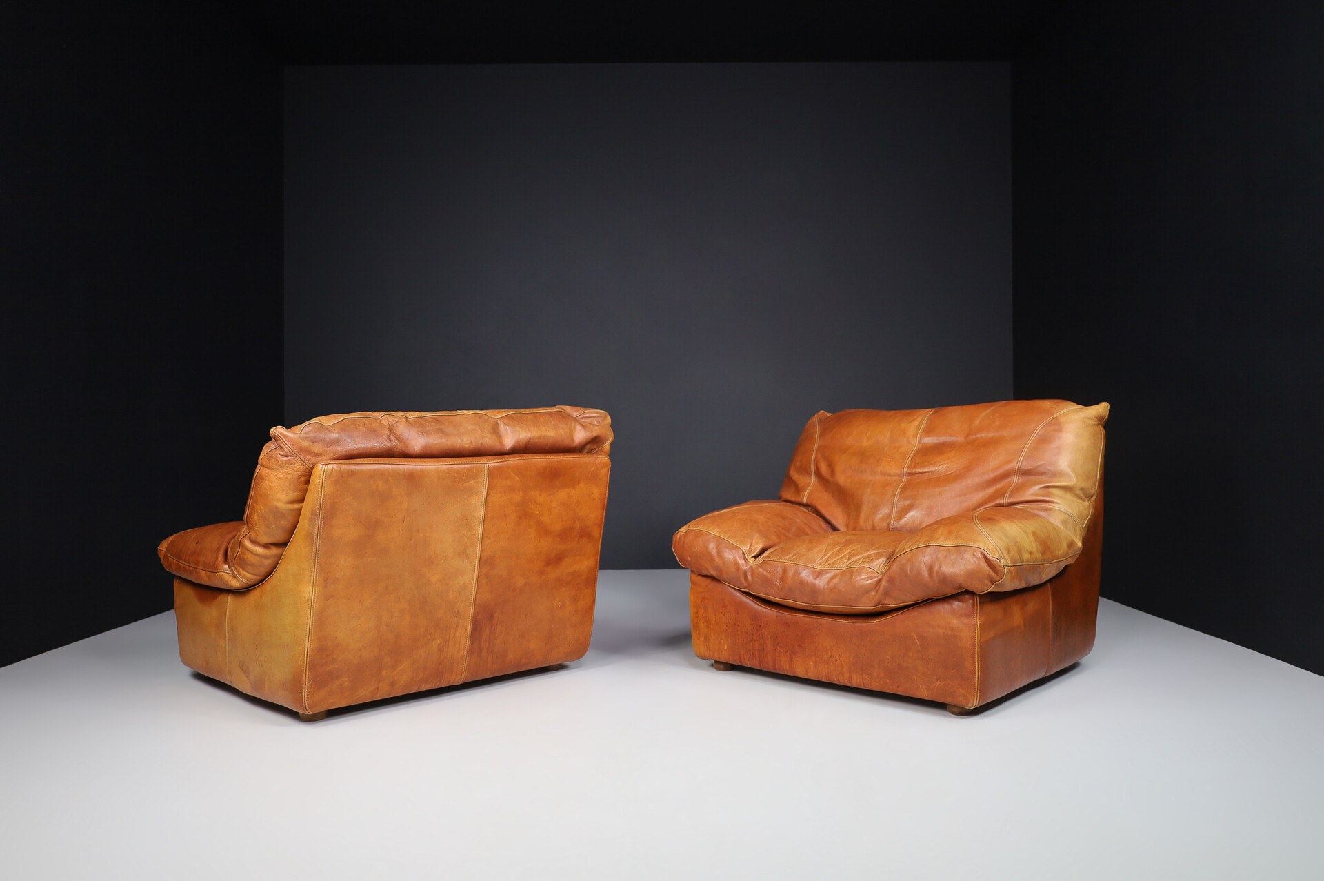 Mid century modern Oversize patinated Cognac leather lounge chairs, France 1970s Late-20th century