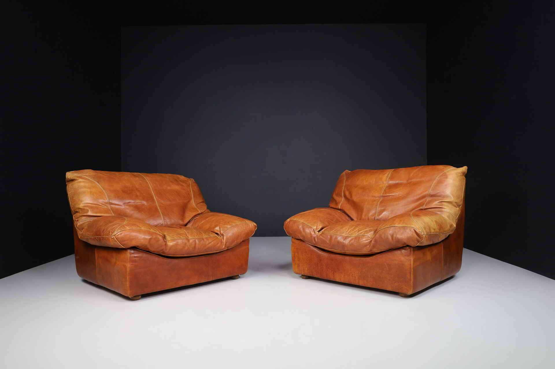 Mid century modern Oversize patinated Cognac leather lounge chairs, France 1970s Late-20th century