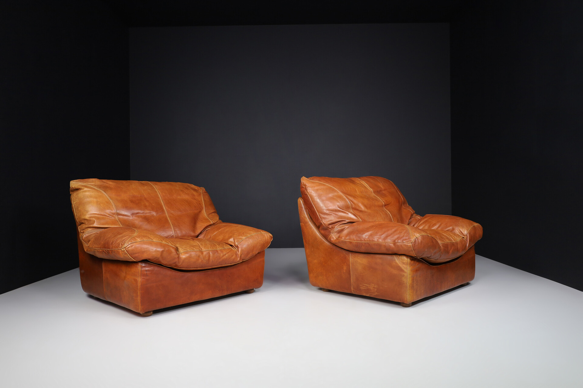 Mid century modern Oversize patinated Cognac leather lounge chairs, France 1970s Late-20th century