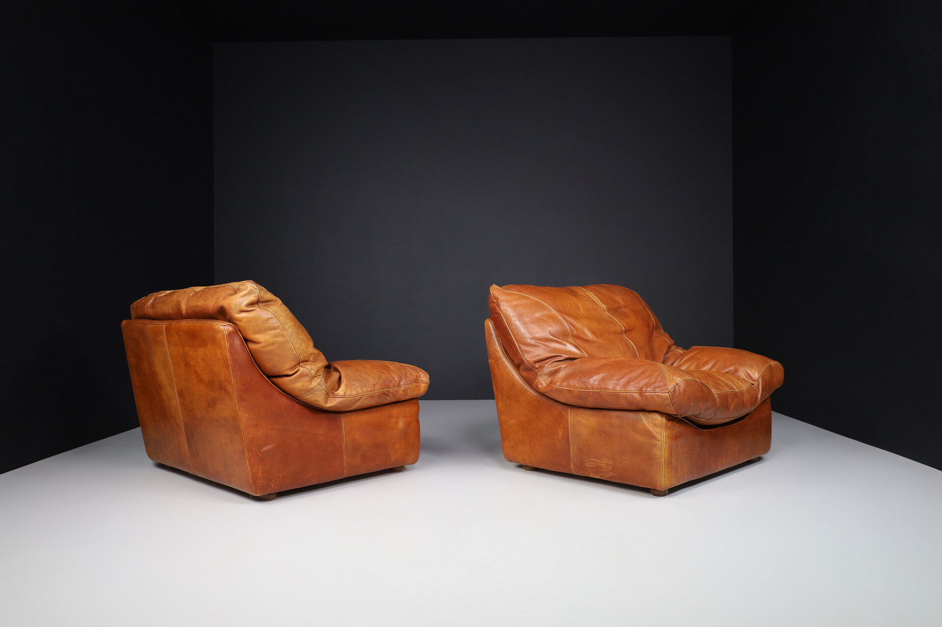 Mid century modern Oversize patinated Cognac leather lounge chairs, France 1970s Late-20th century