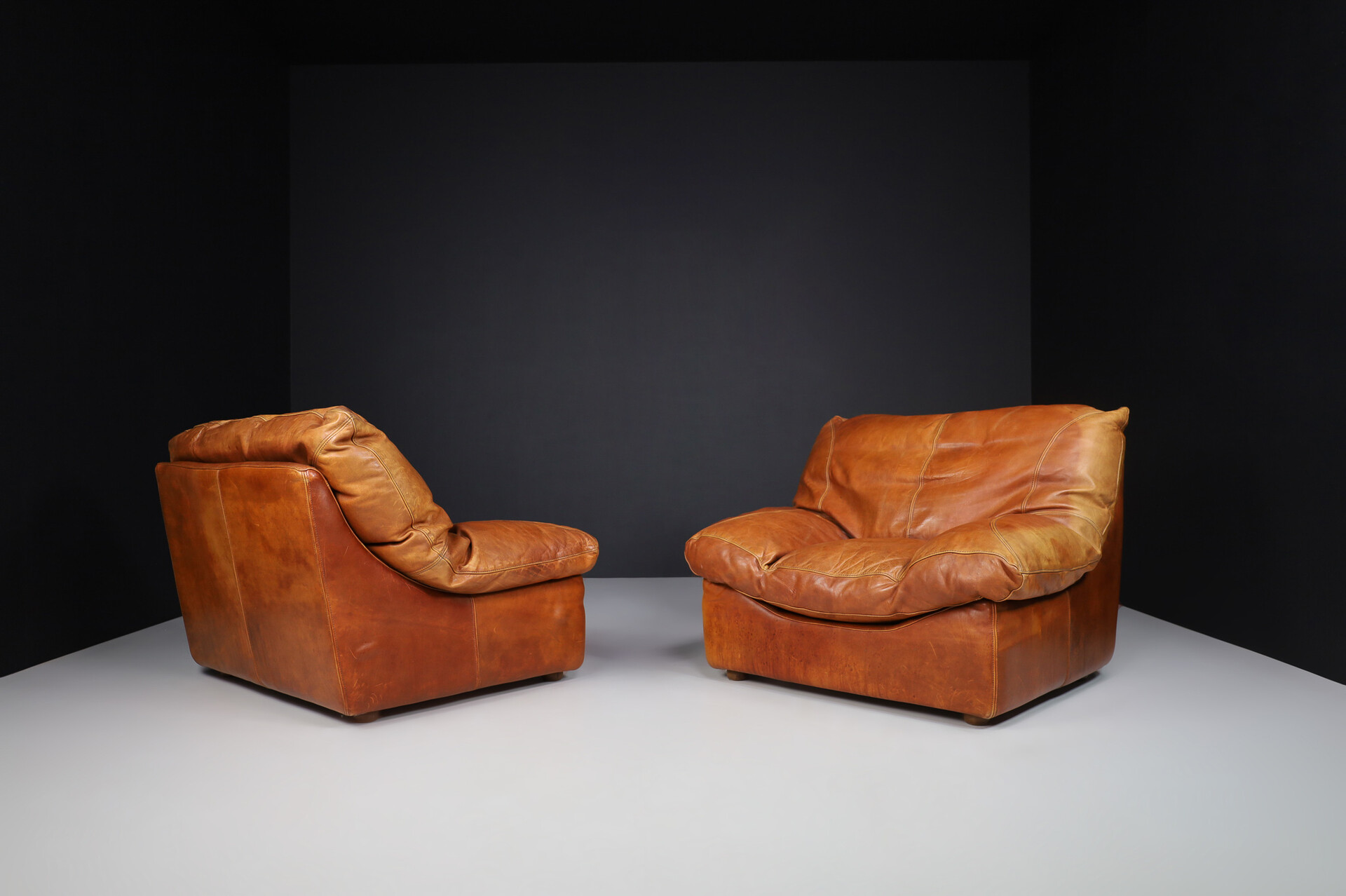 Mid century modern Oversize patinated Cognac leather lounge chairs, France 1970s Late-20th century