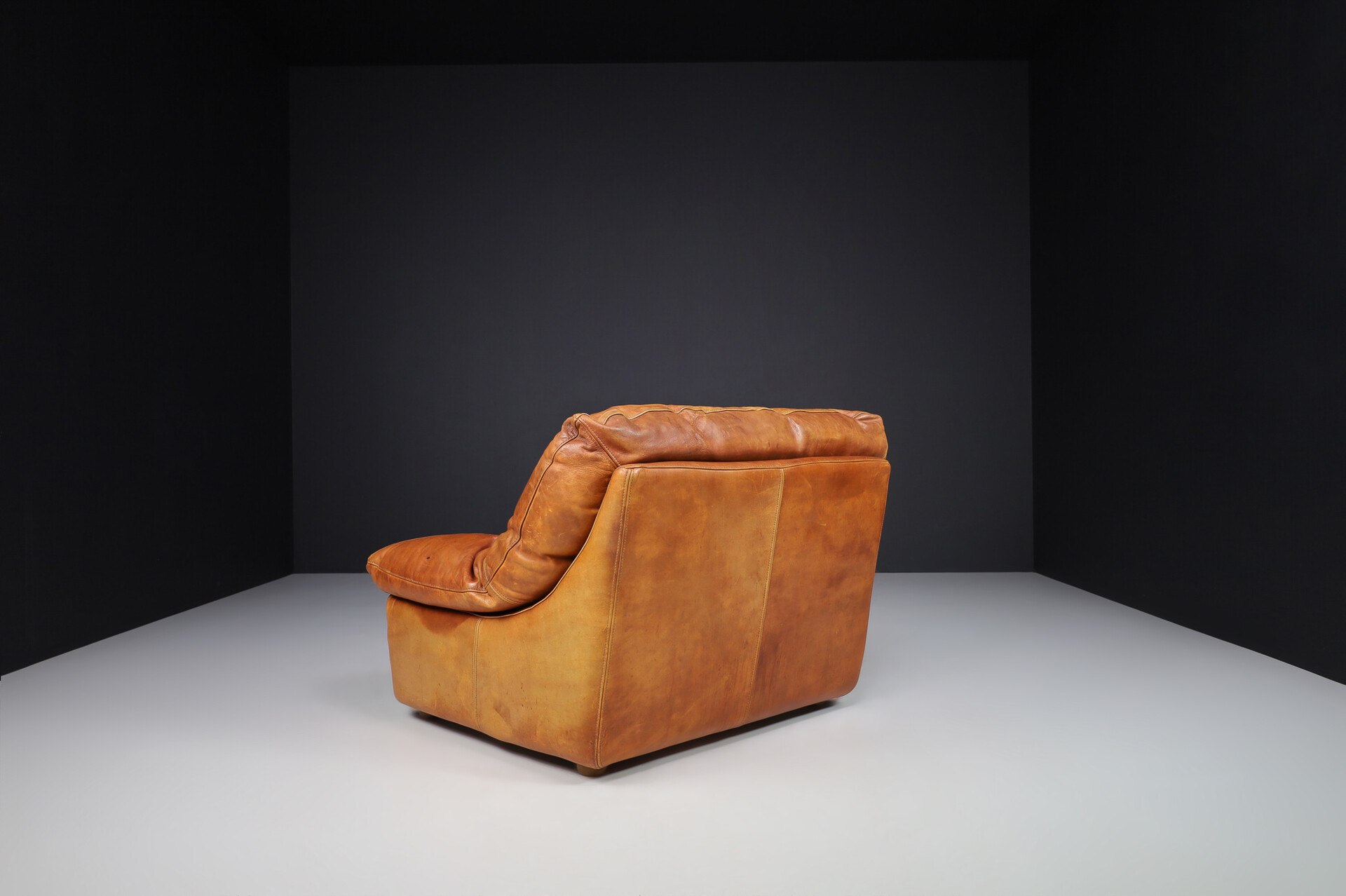 Mid century modern Oversize patinated Cognac leather lounge chairs, France 1970s Late-20th century