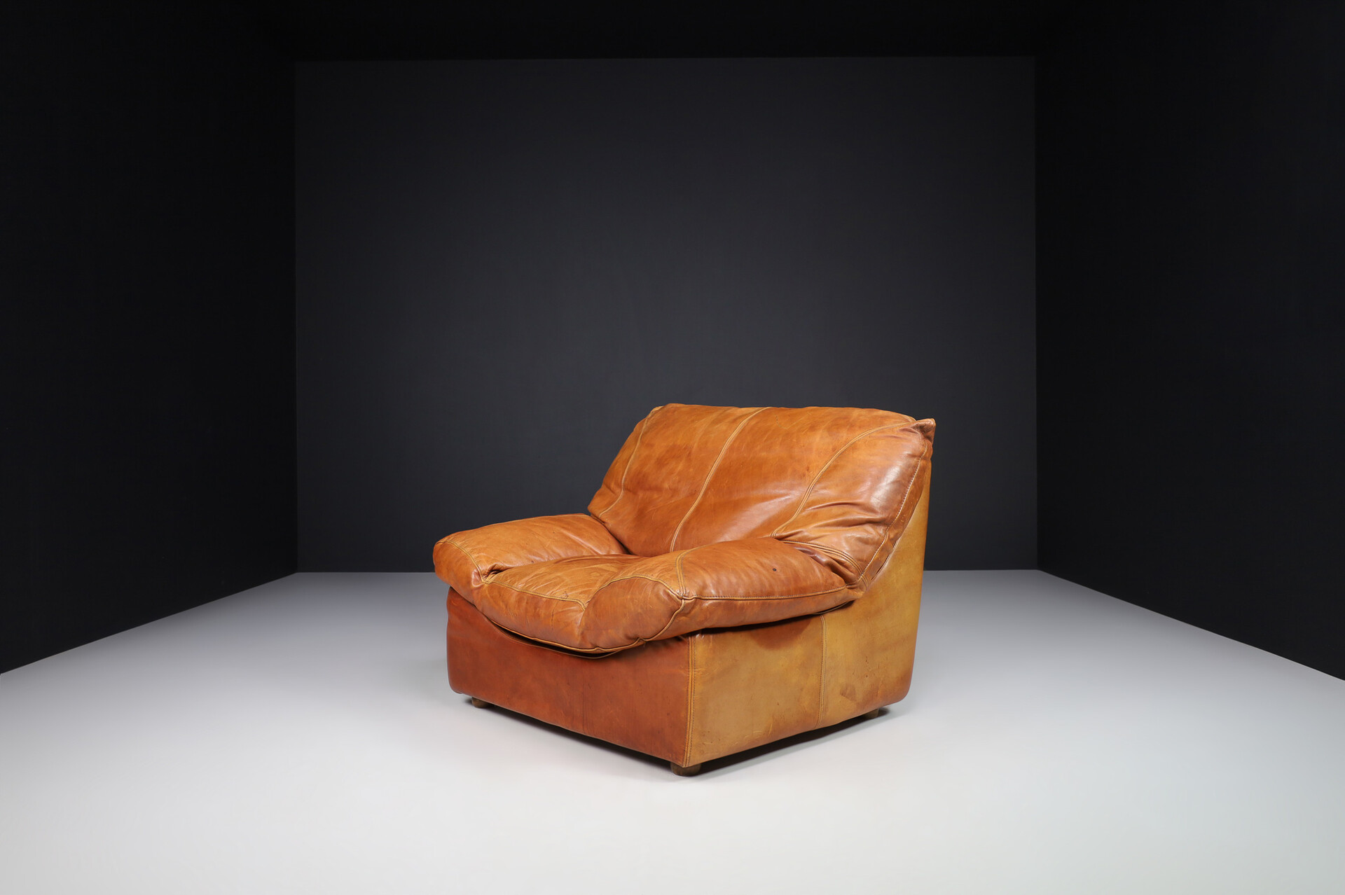 Mid century modern Oversize patinated Cognac leather lounge chairs, France 1970s Late-20th century