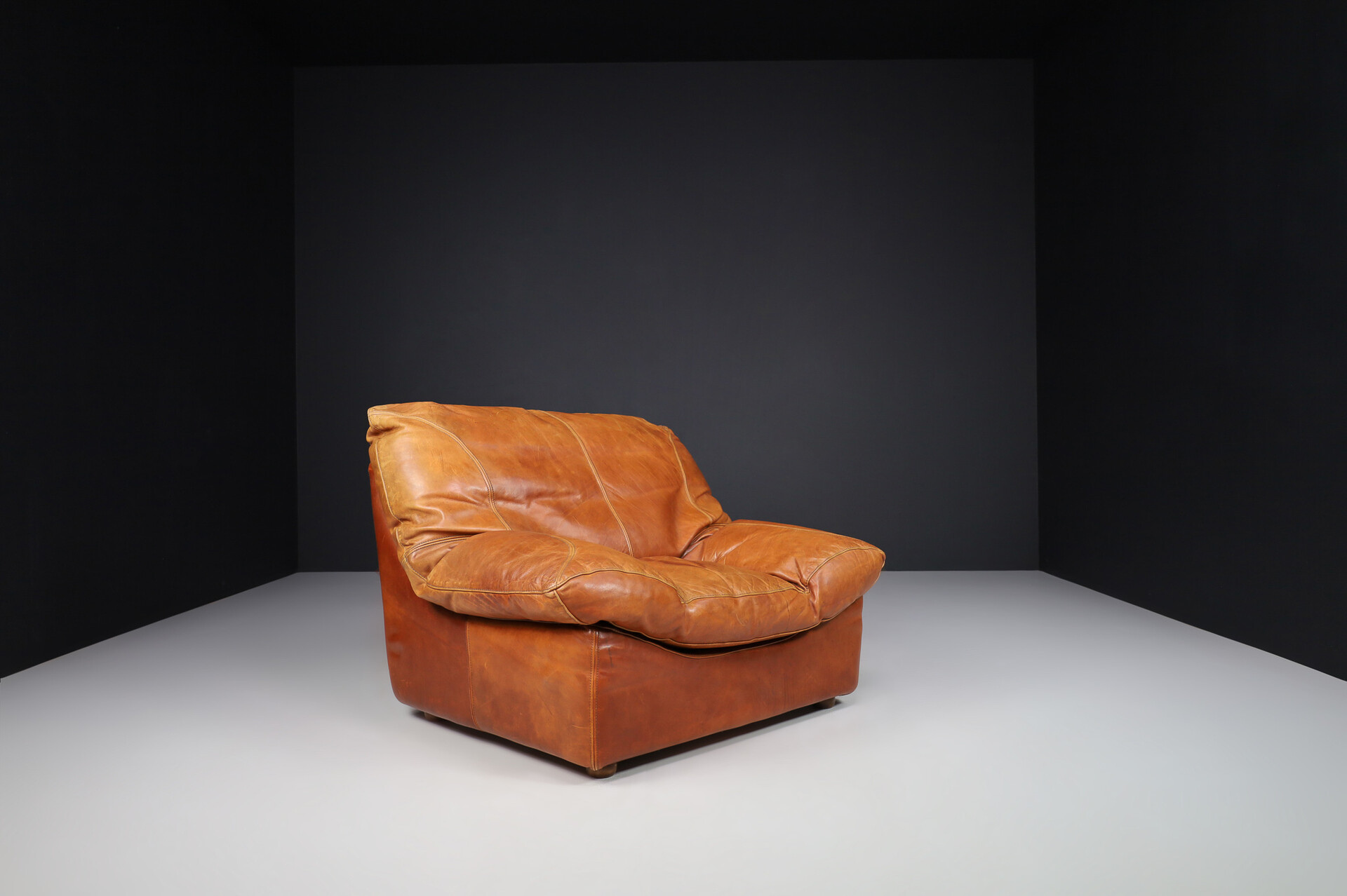 Mid century modern Oversize patinated Cognac leather lounge chairs, France 1970s Late-20th century